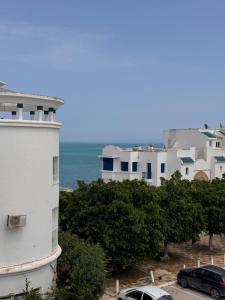 a view of a white building and the ocean at Perle Bleue de Gammarth in Gammarth