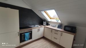 a small kitchen with a sink and a window at Lieblingsort in Freudenstadt