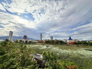 a field of flowers with a city in the background at Treasure Condo Kitchenette Wifi in Chiang Mai