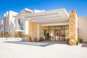 a villa with a view of the courtyard of a house at Ramnus Karpathos Suites in Karpathos