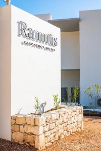 a building with a sign that reads rammns laboratories services at Ramnus Karpathos Suites in Karpathos