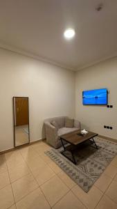 a living room with a couch and a table at ركن النسيم للشقق الفندقية Rukn Al - Naseam Hotel Apartment in Jeddah
