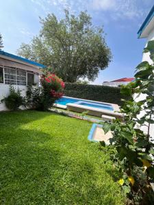 a yard with a swimming pool next to a house at Casa en Cuernavaca Morelos in Cuernavaca