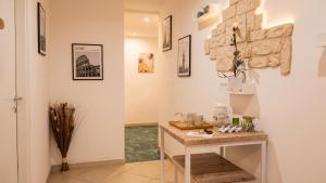 a room with a table and some pictures on the wall at Casa Linda Affitacamere Rozzano HUMANITAS FORUM ASSAGO M2 MILANO Centro IEO in Rozzano