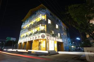 a tall building with lights on at night at Raj Residency in Pondicherry