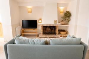 a living room with a couch and a fireplace at Casa Belladona in Calonge