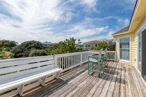 a deck with a bench and a chair on it at Shore is Fun - Duck, Poteskeet, Beach 480 Yds, 3 Min. Walk to Downtown, Pool, Hot Tub, YR Flex in Duck