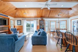a living room with two blue couches and a table at Shore is Fun - Duck, Poteskeet, Beach 480 Yds, 3 Min. Walk to Downtown, Pool, Hot Tub, YR Flex in Duck