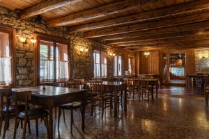 a dining room with wooden tables and chairs at Ristoro la Crosetta in Caneva