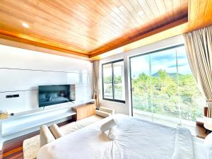 a bedroom with a bed and a large window at Anara Pool Villa 3 Bedrooms in Nathon Bay +72 photos