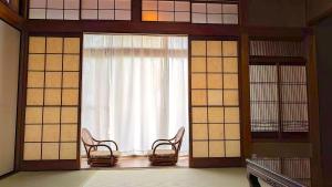 a room with two chairs and a window at 平城空間 - Heijo Space in Nara