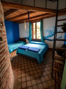 a bedroom with a bunk bed and a window at Hunab Ku Hostel in Capilla del Monte