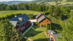 an aerial view of a house on a hill at Agroturystyka Paradiso domki pokoje in Ropa