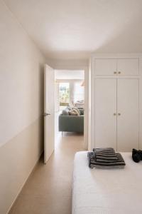 a white bedroom with a bed and a couch at Casa Belladona in Calonge +22 photos