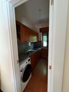 a kitchen with a washing machine and a sink at Villa Chiara in Piscopio