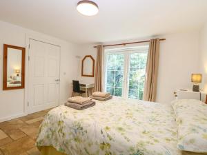 a bedroom with a bed with towels on it at Mill Lodge in Brisley
