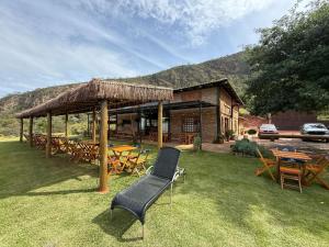 a patio with a table and chairs and a building at Pousada Carraro in Delfinópolis