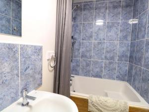a bathroom with a sink and a bath tub at Mill Lodge in Brisley +19 photos
