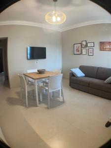 a living room with a table and a couch at Harmony Suite in Aprilia