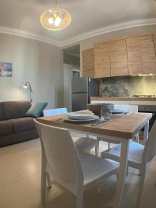 a kitchen and dining room with a table and chairs at Harmony Suite in Aprilia