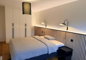 a bedroom with a bed and two lights on the wall at Villa Winbomont in Malmedy +18 photos