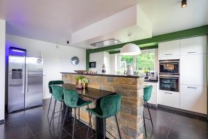 a kitchen with a stone counter and green accents at Villa Winbomont in Malmedy