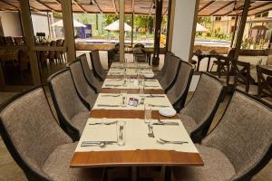 a dining room with a long table and chairs at Accra City Hotel in Accra