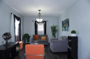 a living room with two couches and a table at West New York room 15 in West New York