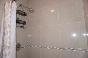 a bathroom with a shower with a shower curtain at West New York room 15 in West New York