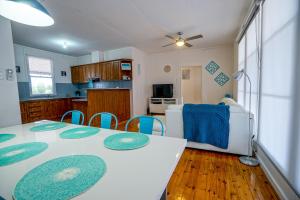 a kitchen and dining room with a table and chairs at Breakaway Moonta Bay in Port Moonta