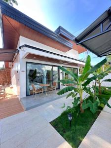 a patio of a house with a table and chairs at Diver's home resort in Panglao Island
