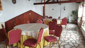 a group of tables and chairs in a room at Pensiunea Iris in Săcele +56 photos