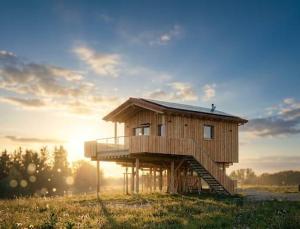 a wooden house sitting on top of a field at Sky Chalets Bühlertal in Bühlertann