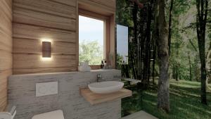 a bathroom with a sink and a window in a forest at Sky Chalets Bühlertal in Bühlertann