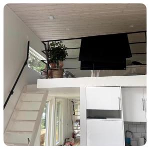 a view of a living room with a tv and a staircase at Seabreeze Pine Retreat in Åhus