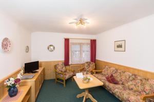 a living room with a couch and a table at Hotel Sonnleiten in Reit im Winkl