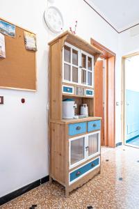 a wooden cabinet with a clock on a wall at Artemisia in Varazze