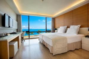 a bedroom with a large bed and a large window at Kalyon Hotel Istanbul in Istanbul