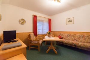 a living room with a couch and a table at Hotel Sonnleiten in Reit im Winkl