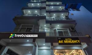 a tall building with a sign in front of it at Treebo AK Residency, Tapovan in Kainūr
