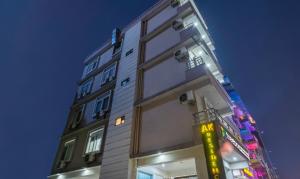 a tall building with a sign on the side of it at Treebo AK Residency, Tapovan in Kainūr +23 photos
