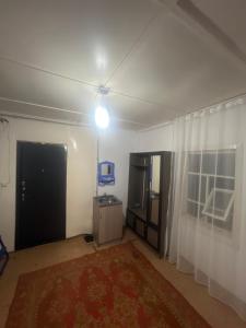 an empty living room with a door and a window at Бекбол in Sovetskoye
