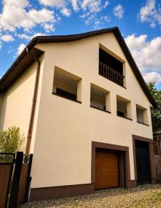 a house with a garage in front of it at Pstrug House in Yasinya