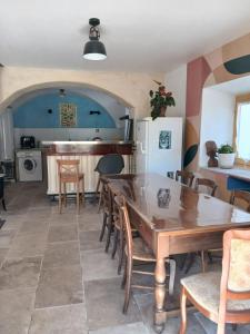 a kitchen and dining room with a table and chairs at Gite Le Romanesque in Clelles