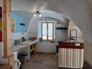 a kitchen with a sink and a window at Gite Le Romanesque in Clelles