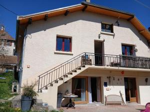 a house with a balcony and a staircase at Gite Le Romanesque in Clelles