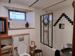 a bathroom with a toilet and a sink at Gite Le Romanesque in Clelles