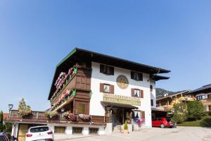 a building with a sign on the side of it at Hotel Sonnleiten in Reit im Winkl
