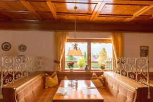 a dining room with a table and a window at Hotel Sonnleiten in Reit im Winkl