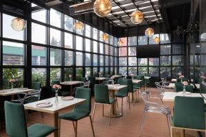 a restaurant with tables and chairs and a flat screen tv at Hotel Black Tower Premium in Bogotá